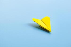 Origami of a single yellow airplane with customizable space for text photo