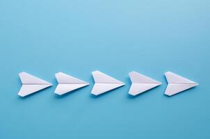Top view of origami white paper airplanes with customizable space for text photo