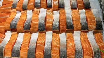 High angle view of slices of salmon fish display at market. Seafood concept photo