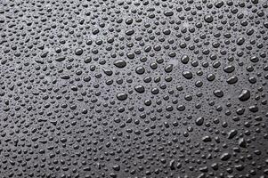 Water droplets with black background. Suitable for wallpaper design background. photo