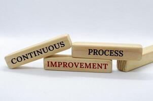 Continuous Process Improvement text on wooden blocks with white background. Process Improvement concept photo