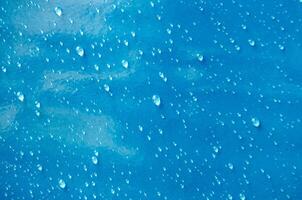 Top view of droplets with blue color background suitable for wallpaper photo