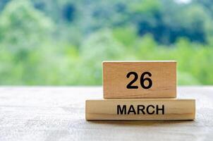 26 March calendar on wooden table with customizable space for text, ideas or messages. Calendar and copy space concept photo