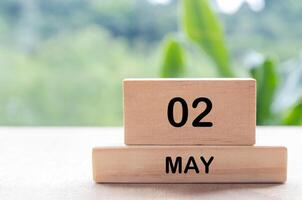 2 May text on wooden blocks with customizable space for text or messages. Month and copy space concept photo