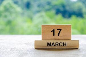 17 March calendar on wooden table with customizable space for text, ideas or messages. Calendar and copy space concept photo
