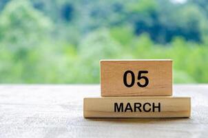 5 March calendar on wooden table with customizable space for text, ideas or messages. Calendar and copy space concept photo
