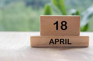 18 April calendar on wooden table with customizable space for text, ideas or messages. Calendar and copy space concept. photo