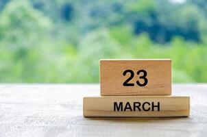 23 March calendar on wooden table with customizable space for text, ideas or messages. Calendar and copy space concept photo