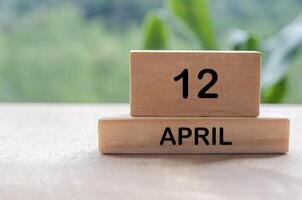 12 April calendar on wooden table with customizable space for text, ideas or messages. Calendar and copy space concept photo