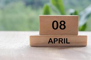 8 April calendar on wooden table with customizable space for text, ideas or messages. Calendar and copy space concept photo