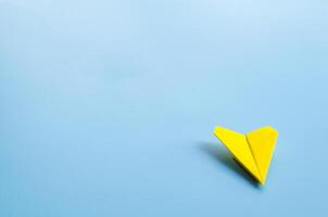 Low view of origami yellow paper airplane with customizable space for text. photo