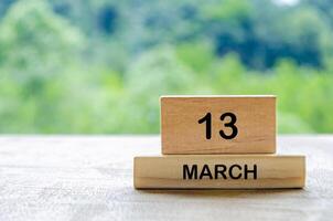 13 March calendar on wooden table with customizable space for text, ideas or messages. Calendar and copy space concept photo