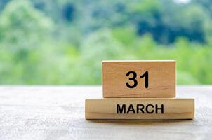 31 March calendar on wooden table with customizable space for text, ideas or messages. Calendar and copy space concept photo