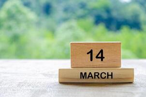 14 March calendar on wooden table with customizable space for text, ideas or messages. Calendar and copy space concept photo
