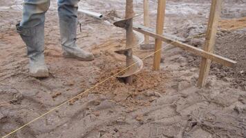 An auger drill is utilized at a construction site specifically for the purpose of digging foundations effectively video