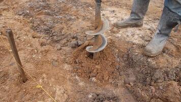 A detailed closeup view of an auger actively being utilized for soil excavation in preparation for construction video