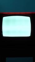 vertical Old analog television set displaying static white noise in dark room video