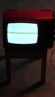 vertical Old red television showing static noise on wooden floor video