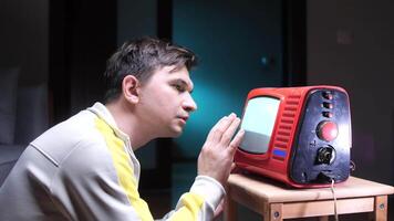 a man touches the screen of an old vintage tube TV. the concept of a mystical mood video