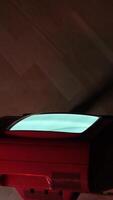 vertical Old red television showing static noise on wooden background video