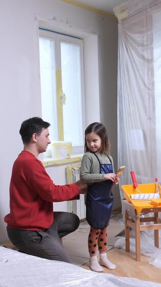 vertical Father and daughter giving high five while painting room together. family together 56168959 Stock Video at Vecteezy