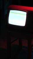 vertical Old analog television set displaying static noise in dark room video
