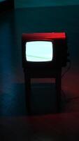 vertical Old analog television set displaying static noise in dark room video