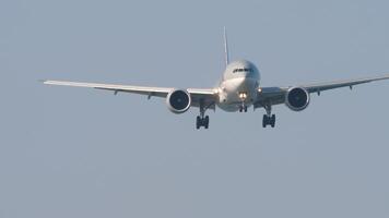 Footage of airplane landing, front view, long shot. Airliner descending. Plane in the sky. Travel concept video
