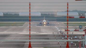 Aircraft acceleration for takeoff, view from the end of the runway. Tourism and travel concept video
