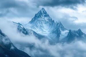 A mountain is covered in snow and clouds photo