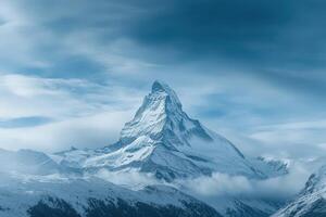 A mountain with snow on top and a blue sky photo