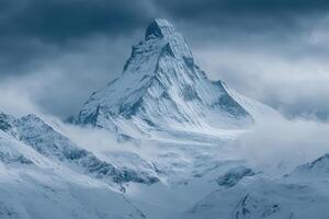 A mountain with snow on it is shown in this photo