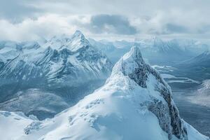 A snowy mountain top with a person standing on top photo