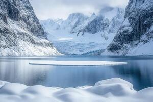 A lake surrounded by snow covered mountains photo