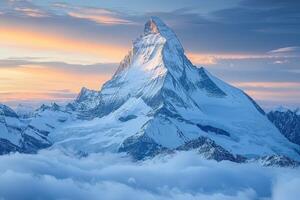 A mountain peak is seen in the clouds photo