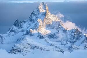 A mountain peak is covered in snow photo