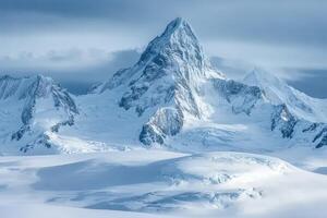 A large mountain covered in snow with a cloudy sky photo