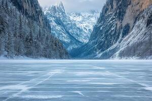A frozen lake surrounded by mountains and trees photo