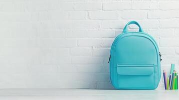 Stylish light blue backpack with colorful pencils on white table against brick wall background, back to school Copy space for text, 4K photo