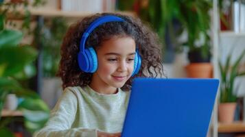 Happy elementary school student education using laptop and headphones, enjoying online lesson at home online home schooling photo