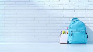 Stylish light blue backpack with colorful pencils on white table against brick wall background, ready for back to school for text, 4K photo