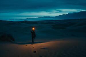 A person standing in the middle of a desert holding a torch photo