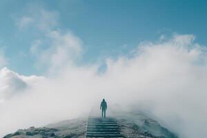 A person standing on a set of stairs in the fog photo