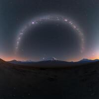 A virtual reality image of a mountain with a rainbow photo