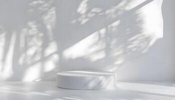 A white table with a white chair in front of a wall photo