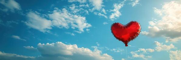 A red heart shaped balloon floating in the sky photo