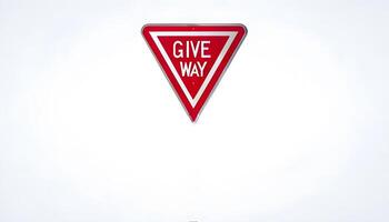 A red and white give way sign on a white background photo