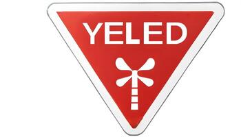 A red and white triangular sign with the word yeled on it photo