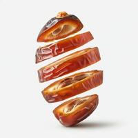 Fresh slice of dates fruit elegantly placed on white background for minimalist food styling photo
