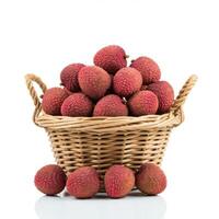 Whole fresh lychee spilling from a basket on a white background, capturing its vibrant color and natural beauty photo